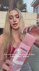 A woman holding SatinGel Caramel flavored water-based lubricant bottle while sharing her genuine personal experience and positive feelings on camera